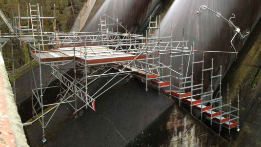 complex scaffold built around pipes at a steep angle